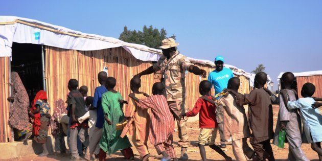 Children race into a newly-built classroom in a refugee camp in Maiduguri, Nigeria, in January 2017.