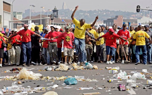 Striking municipal workers emptied rubbish bins into the street as they marched on the Durban City Hall; July 30 2009.