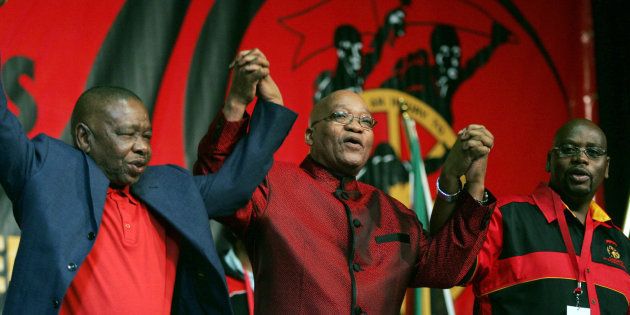 President Jacob Zuma (C) holds hands with former minister of higher education Blade Nzimande (L) and president of Cosatu, Sdumo Dlamini (R).
