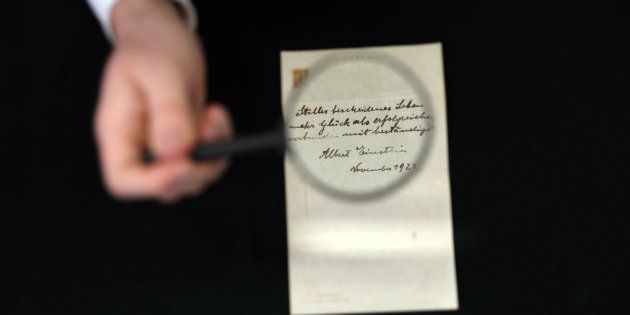 A note written on a Tokyo hotel official paper in 1922 by Albert Einstein is seen before it is sold at an auction in Jerusalem, October 24, 2017. REUTERS/Ammar Awad