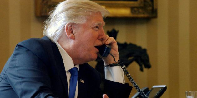 U.S. President Donald Trump speaks by phone with Russia's President Vladimir Putin in the Oval Office at the White House in Washington, U.S. January 28, 2017.