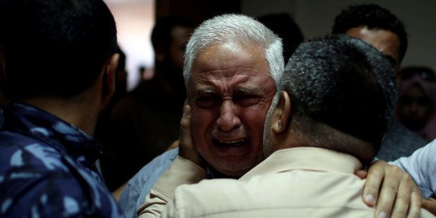 A relative of Palestinian Ahmed al-Rantisi, who was killed during a protest at the Israel-Gaza border, is consoled at a hospital in northern Gaza. May 14 2018.