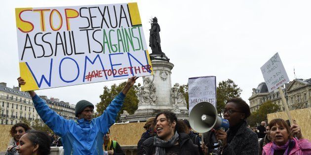 French activist Jean-Baptiste Redde, aka Voltuan, holds a placard as protesters take part in a gathering against gender-based and sexual violence in Paris on October 29, 2017.