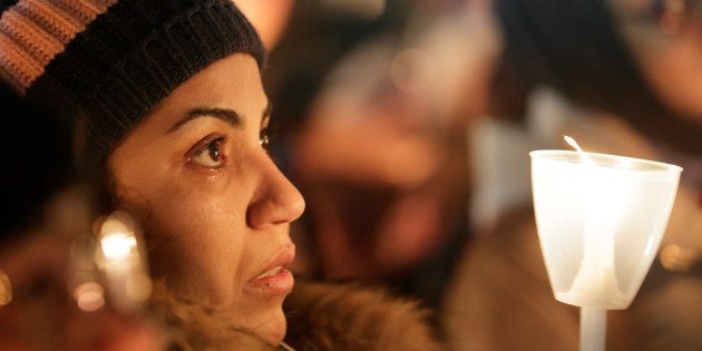 A woman becomes emotional during a vigil in support of the Muslim community in Montreal, Quebec, January 30, 2017. REUTERS/Dario Ayala