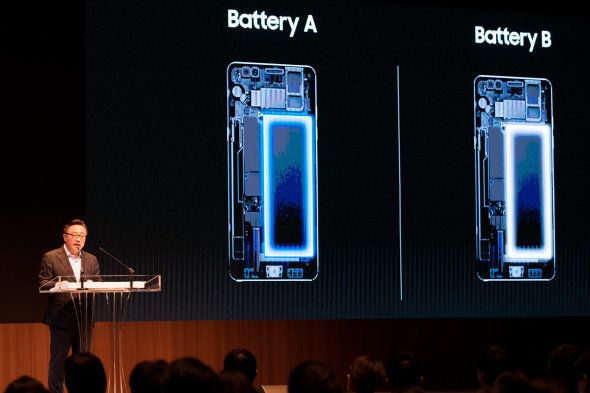 Koh Dong-jin, president of mobile communications at Samsung Electronics Co., speaks as various types of batteries used in the company's Galaxy Note 7 smartphones are displayed on a screen during a news conference in Seoul, South Korea, on Monday, Jan. 23, 2017.