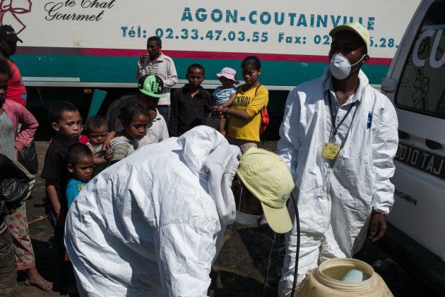 Council workers fill containers as they prepare to spray disinfectant during the clean-up of the market of Anosibe in the Anosibe district, one of the most unsalubrious district of Antananarivo on October 10, 2017. The World Health Organization has warned that a deadly outbreak of the plague, which began in late August, has claimed more than 20 lives in Madagascar and is swiftly spreading in cities across the country. Rats are porters of fleas which spread the bubonic plague and are attracted by garbages and unsalubrity. Pneumonic plague, which is passed through person-to-person transmission, has also been recorded. / AFP PHOTO / RIJASOLO (Photo credit should read RIJASOLO/AFP/Getty Images)