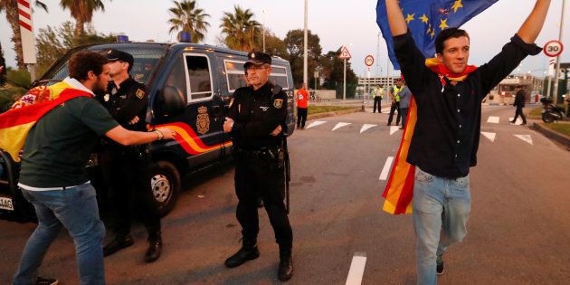 Pro-unity supporters greet Spanish national police who are on stand-by near the Port of Barcelona, in a show of solidarity, in Barcelona, Spain, October 28, 2017. REUTERS/Yves Herman