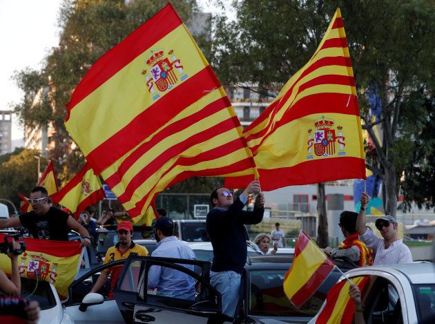 Pro-unity demonstrators wave the Spanish and Catalan flags as they gather in Barcelona, Spain, October 28, 2017. REUTERS/Yves Herman TPX IMAGES OF THE DAY