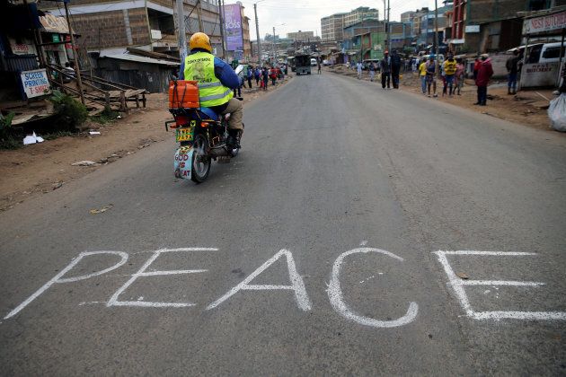 A man rides a motorbike past the word "Peace" in Kawangware slums in Nairobi, Kenya October 28, 2017. REUTERS/Thomas Mukoya