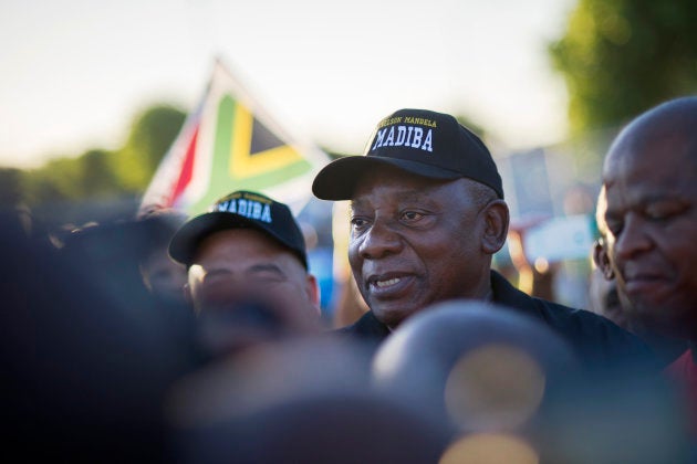 President Cyril Ramaphosa (C) walks on an early morning from Guguletu township to Athlone Stadium.