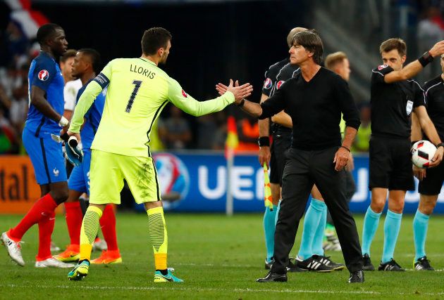 Germany head coach Joachim Low shakes hands with France's Hugo Lloris after the game as referee Nicola Rizzoli and the match officials look on REUTERS/Kai Pfaffenbach Livepic