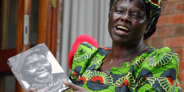 Kenyan Assistant Minister for Environment and Nobel Peace Laureate Wangari Maathai holds her book during a photo session for the launch of the book in Nyeri District, Kenya, September 30, 2006.