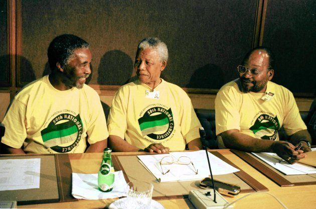 President Nelson Mandela of South Africa is flanked by his deputy Thabo Mbeki (L) and African National Congress (ANC) National Chairman Jacob Zuma at the ANC's 50th National Congress at Northwest University in Mmabato, northwest of Johannesburg, 16 December 1997. At this conference, Mandela will be stepping down as the president of the ANC and leaving the presidency to Mbeki. / AFP / WALTER DHLADHLA (Photo credit should read WALTER DHLADHLA/AFP/Getty Images)