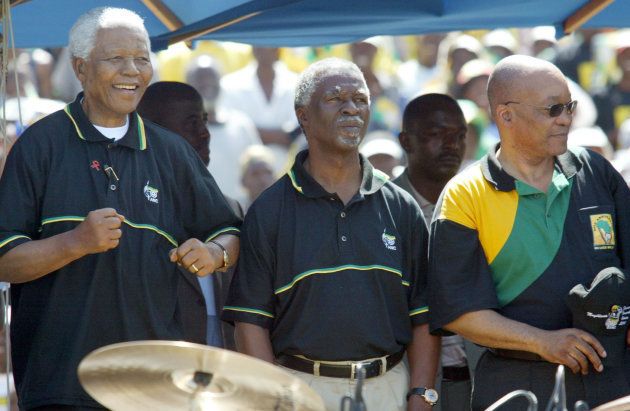 Former South African President Nelson Mandela, President Thabo Mbeki (C) and Deputy President Jacob Zuma (R) dance during an ANC elections campaign rally in Soweto at a stadium near Johannesburg April 4,2004. Mbeki's African National Congress is expected to retain its huge parliamentary majority in the April 14 election, the third since white rule ended in 1994. REUTERS/Juda Ngwenya