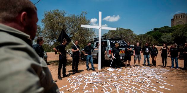 Members of the South African civic organisation, Afriforum and others in solidarity with the #Blackmonday movement pray during a demonstration against farm murders, at the Voortrekker Monument in Pretoria on October 30, 2017.Thousands of white farmers blocked roads in South Africa on Monday to protest against what they say is an explosion of violence against their communities in rural areas. Large demonstrations under the 'Black Monday' banner were held in Cape Town, Johannesburg and the capital Pretoria. Marchers dressed in black to commemorate the victims of hundreds of deadly 'farm attacks' in recent years. / AFP PHOTO / GULSHAN KHAN (Photo credit should read GULSHAN KHAN/AFP/Getty Images)