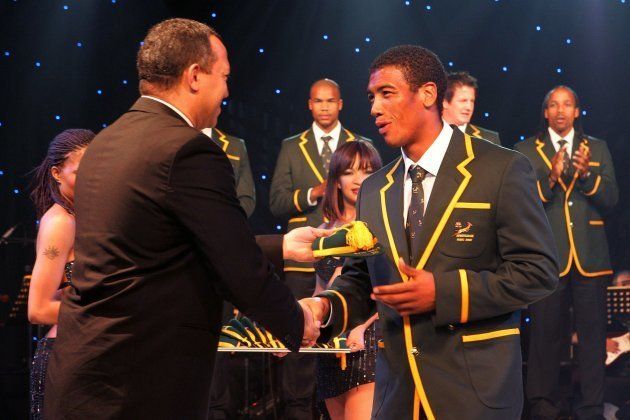 Oregan Hoskins hands Ashwin Willemse his cap during the 2007 Rugby World Cup capping ceremony during the Sasol Springboks Farewell dinner held at the Sandton Convention Centre on September 2 2007.