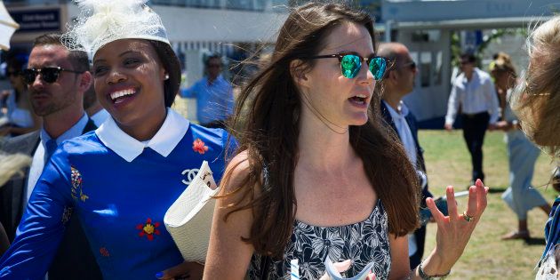People attend the L'Ormarins Queen's Plate horse racing event, a combination of horse racing and elegant attire, with a dress code of blue and white, at the Kenilworth racecourse in Cape Town, South Africa, on January 7, 2017.