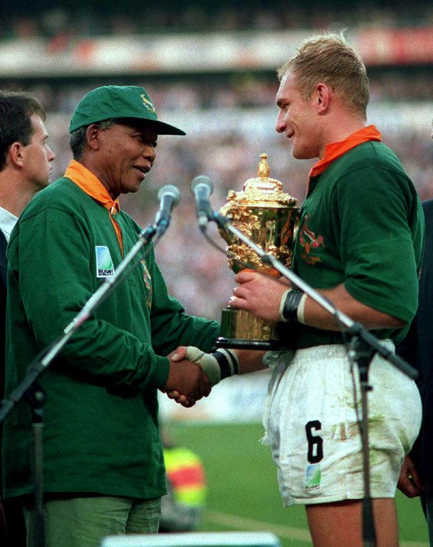Nelson Mandela hands over the William Webb Ellis Cup to Springbok captain Francois Pienaar after the Rugby World Cup final: June 24 1995.