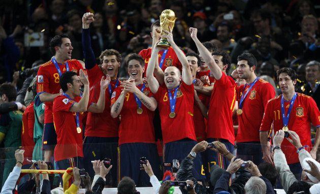 Spain's winning goalscorer Andres Iniesta (6) celebrates victory as he lifts the world cup trophy