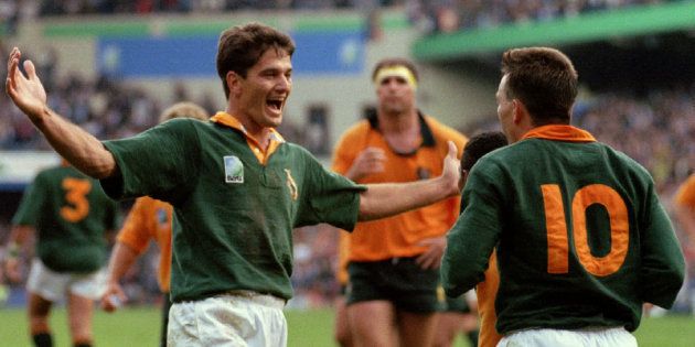 A jubilant South African scrumhalf Joost van der Westhuizen (L) congratulates teammate Joel Stransky (R) after Stransky scored a try during their Rugby World Cup opener against Australia, 25 May. South Africa defeated the defending champions 27-18
