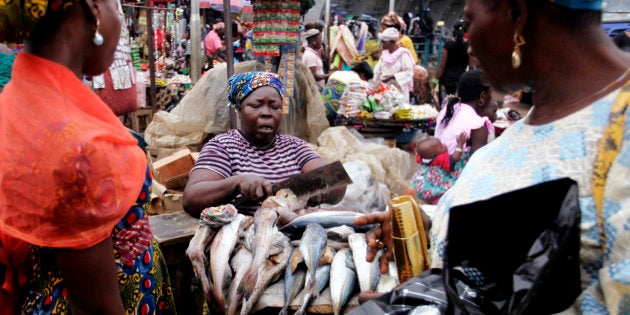 A woman sells fish at a street market in Lagos June 4, 2011.