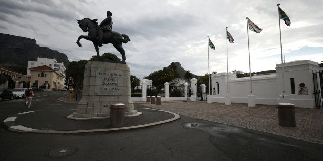 Flags fly behind the statue of Louis Botha, South Africa's first Prime Minister, outside Parliament in Cape Town, South Africa, February 13, 2018.