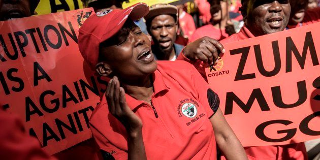 Cosatu members cheer and dance as they march through the streets protesting against corruption on September 27, 2017 in Johannesburg.