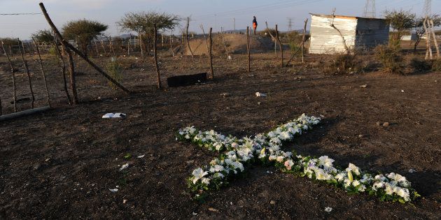 A remembrance cross made of flowers is seen during last year's commemoration of the 2012 Marikana massacre in Rustenburg. August 16, 2016 marks 4 years since 34 miners were killed during a wage increase protest at Lonmin mine. (Felix Dlangamandla/Beeld/Gallo)