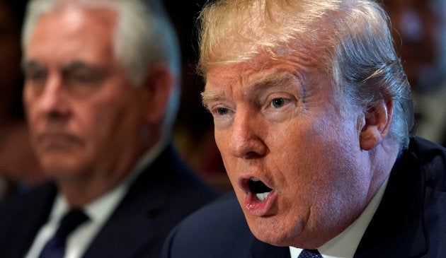 Secretary of State Rex Tillerson (L) sits beside U.S. President Donald Trump during a cabinet meeting at the White House in Washington, U.S., November 1, 2017. REUTERS/Kevin Lamarque