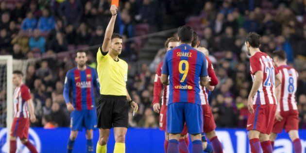 The referee shows the red card to Luis Suarez (9) of Barcelona during the King's Cup match between FC Barcelona and Atletico de Madrid at Camp Nou Stadium in Barcelona, Spain on February 7, 2017.
