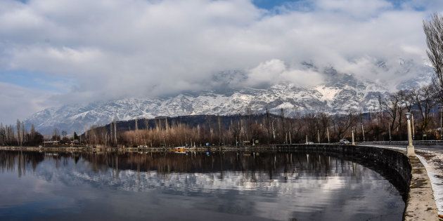 Shikara boats are moored the bank of Dal lake next to the snow clad mountains in Dal Lake on February 06, 2017 in Srinagar, the summer capital of Indian Administered Kashmir, India. Cold weather continued in the Kashmir valley with most places in the state recording sub-zero temperatures.(Photo by Yawar Nazir/Getty Images)