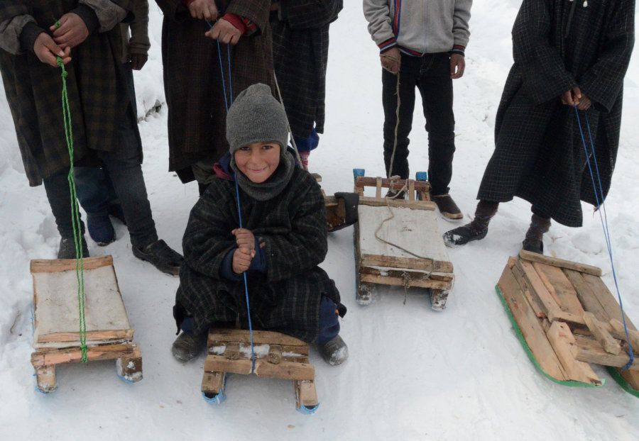 Kashmiri children enjoy sledge ride near Gund, about 80 kilometers (50 miles) north of Srinagar, on January 14, 2017 in Kashmir, India. Photo credit Imran Bhat / Barcroft Images / Barcroft Media via Getty Images