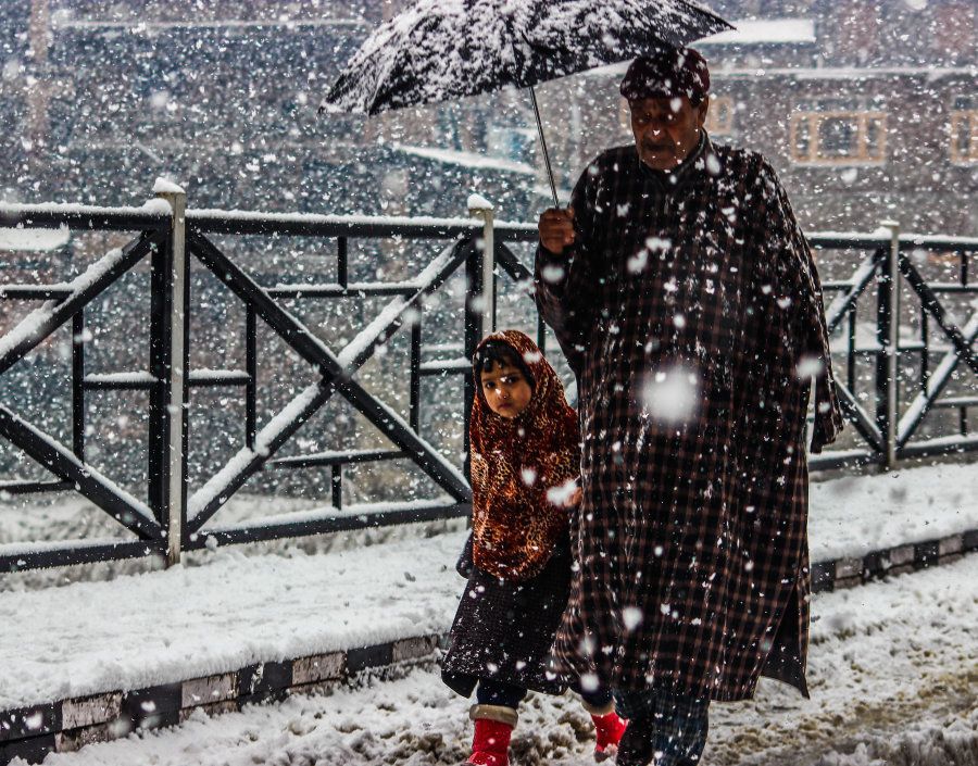 A man and his daughter seen making their way through heavy snowfall, on January 6, 2017 in Kashmir, India. Photo by Owais Khursheed Shah / Barcroft Images