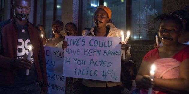 Demonstrators gathered in front of the office of the presidency of Gauteng State hold placards during a protest held over the death of 94 psychiatry patients sent to civil society organization headquarters by the Esidimeni Clinic in Johannesburg due to the high costs of treatment, in Johannesburg on February 2, 2017.