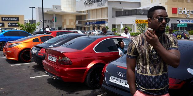 Affluent men meet and show off their fancy sport cars at a shopping mall parking on April 19, 2015 in Accra, Ghana.