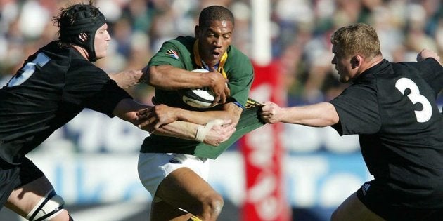 South African rugby player Ashwin Willemse (in green jersey) playing against New Zealand’s All Blacks in 2003.