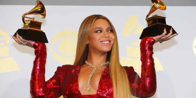 Beyonce holds the awards she won for Best Urban Contemporary Album for