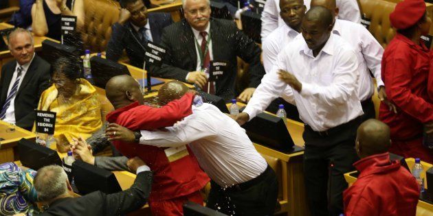 Security personnel remove Economic Freedom Fighters (EFF) MP out of Parliament during the State of the Nation Address.