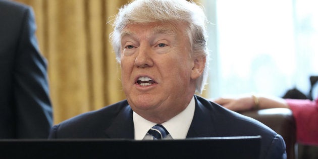 U.S. President Donald Trump reads from an executive order he signed in the Oval Office of the White House February 9, 2017 in Washington, DC. Prior to signing the three executive orders, Trump participated in the swearing in ceremony for new Attorney General Jeff Sessions.