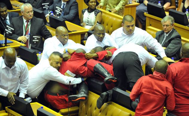 Security personnel remove Economic Freedom Fighters (EFF) MP out of Parliament during the State of the Nation Address (SONA) on February 09, 2017.