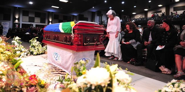 Simphiwe Ngema stands in front of her late husband Dumi Masilela's coffin during his funeral service at Hope Restoration Ministries on August 12, 2017, in Kempton Park.