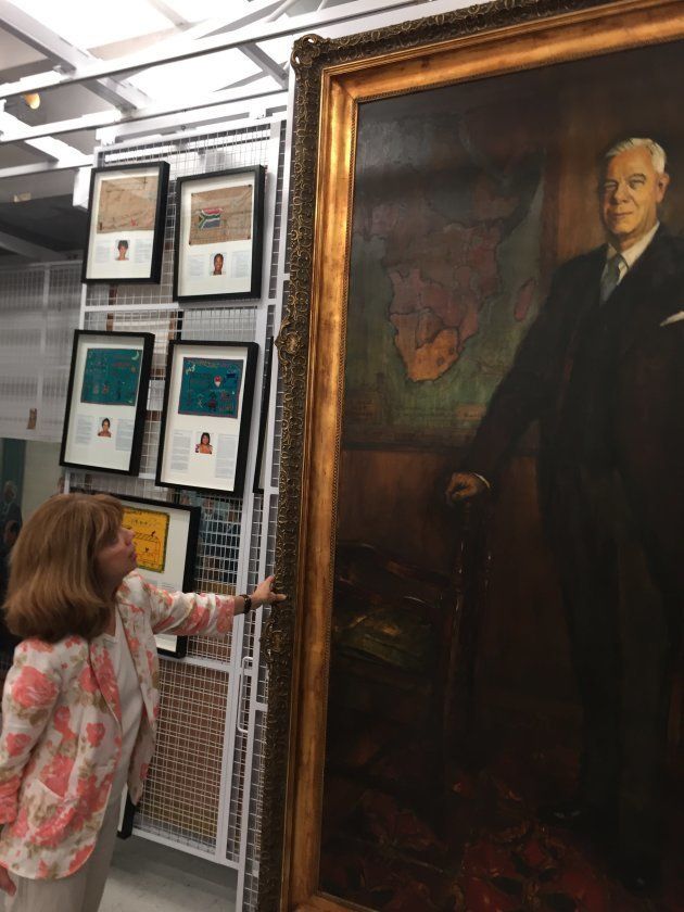 Lila Komnick, administrator of parliament's art collection, with the official portrait of apartheid premier Hendrik Verwoerd. It is kept in a climate controlled room underneath the National Assembly.