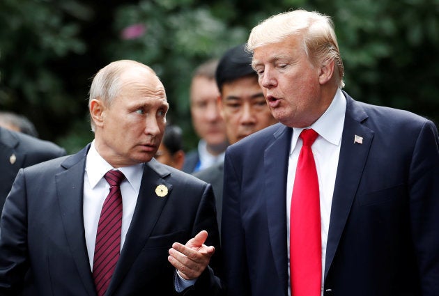 U.S. President Donald Trump and Russia's President Vladimir Putin talk during the family photo session at the APEC Summit in Danang, Vietnam November 11, 2017.