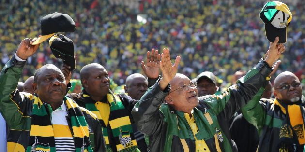 African National Congress (ANC) president,Jacob Zuma (2nd R) waves to his supporters as he arrives for the parties traditional Siyanqoba rally.