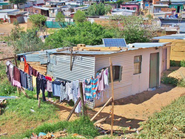 Solar panels on the roof of shack at Informal settlement - Enkanini, on the outskirts of Stellenbosch, Western Cape, South Africa.