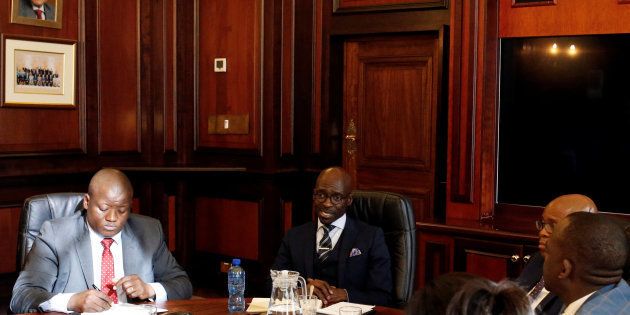 Finance Minister Malusi Gigaba (2nd R) speaks with members of Treasury during his visit to their offices in Pretoria, South Africa, March 31, 2017.