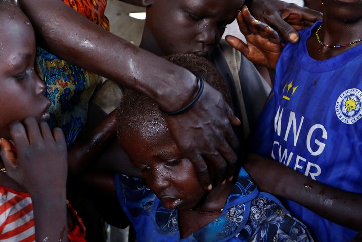 Nyagonga Machul, 38, embraces her children (L-R) Nyameer Mario, 6, Nyawan Mario, 4, Ruai Mario, 10, and Machiey Mario, 8, after being reunited with them at the United Nations Mission in South Sudan (UNMISS) Protection of Civilian site (CoP) in Juba, South Sudan, February 13, 2017. REUTERS/Siegfried Modola