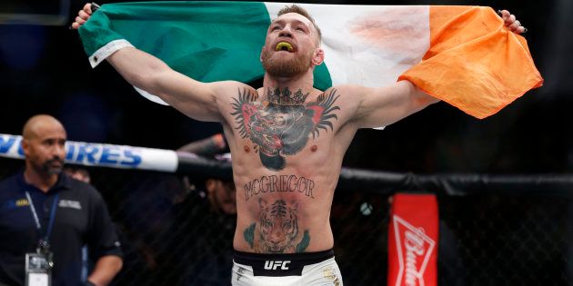 Conor McGregor (blue gloves) celebrates after defeating Eddie Alvarez (red gloves) in their lightweight title bout during UFC 205 at Madison Square Garden.