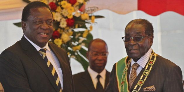 President Robert Mugabe (R) greets Vice President Emmerson Mnangagwa as he arrives for Zimbabwe's Heroes Day commemorations in Harare, August 10, 2015. REUTERS/Philimon Bulawayo