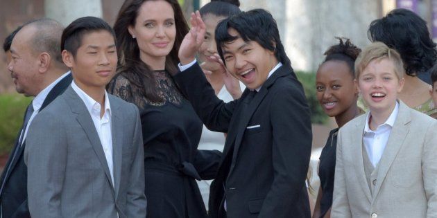  Angelina Jolie and her children gesture to media in front of the royal residence for a meeting with Cambodian King Norodom Sihamoni in Siem Reap on Feb. 18.